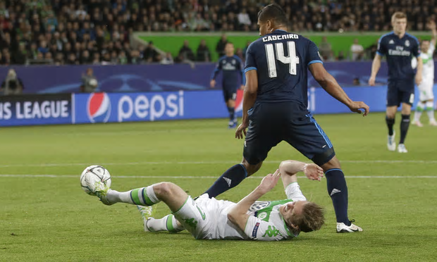 Andre Schurrle fouled by Casemiro in the box.