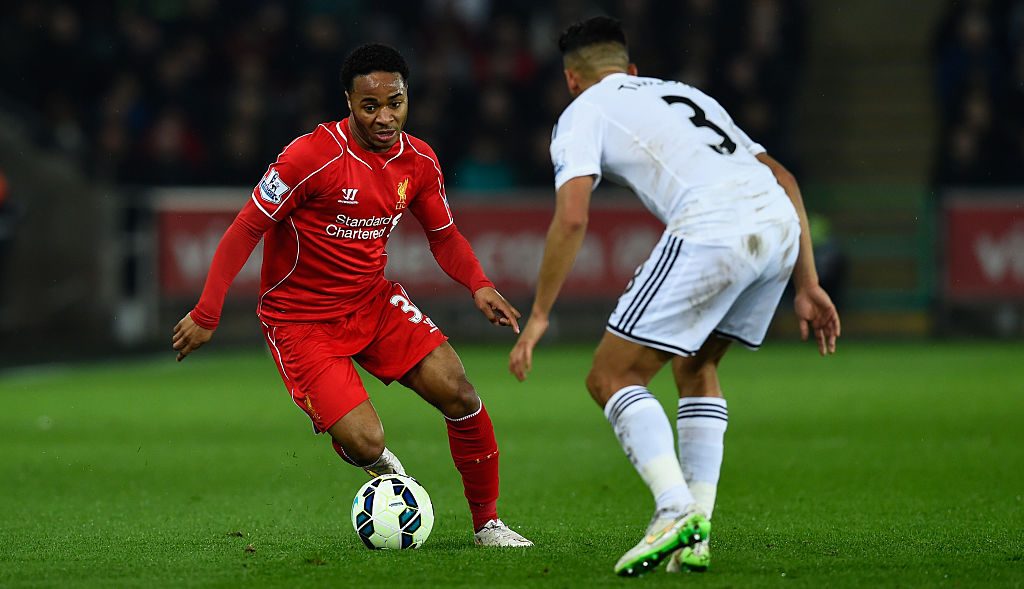 SWANSEA, WALES - MARCH 16: Liverpool player Raheem Sterling (l) takes on Neil Taylor of Swansea during the Barclays Premiership match between Swansea City and Liverpool at Liberty Stadium on March 16, 2015 in Swansea, Wales. (Photo by Stu Forster/Getty Images)
