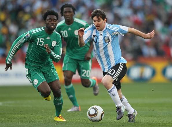 JOHANNESBURG, SOUTH AFRICA - JUNE 12: Sani Kaita of Nigeria chases Lionel Messi of Argentina during the 2010 FIFA World Cup South Africa Group B match between Argentina and Nigeria at Ellis Park Stadium on June 12, 2010 in Johannesburg, South Africa. (Photo by Christof Koepsel/Getty Images)