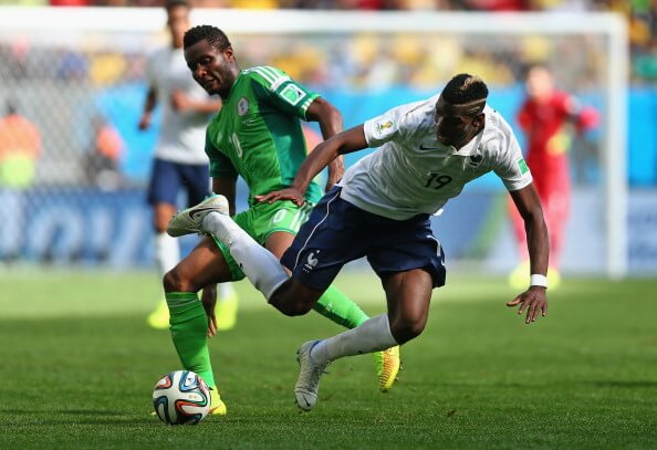 BRASILIA, BRAZIL - JUNE 30: John Obi Mikel of Nigeria challenges Paul Pogba of France during the 2014 FIFA World Cup Brazil Round of 16 match between France and Nigeria at Estadio Nacional on June 30, 2014 in Brasilia, Brazil. (Photo by Jeff Gross/Getty Images)