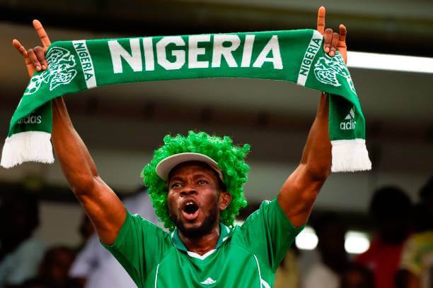 A Nigerian fan waves a scarf as he celebrates after the FIFA World Cup 2018 qualifying football match between Nigeria and Zambia in Uyo, Akwa Ibom State, on October 7, 2017. / AFP PHOTO / PIUS UTOMI EKPEI (Photo credit should read PIUS UTOMI EKPEI/AFP/Getty Images)